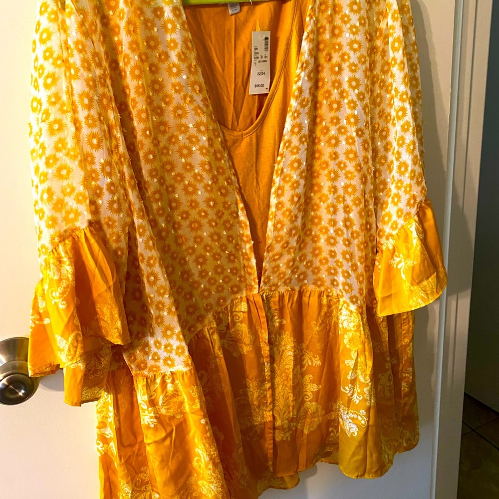 Blouse with sheer overlay.